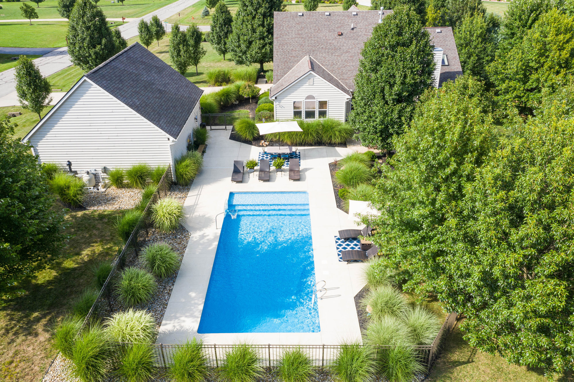 Aerial view of an estate home with swimming pool