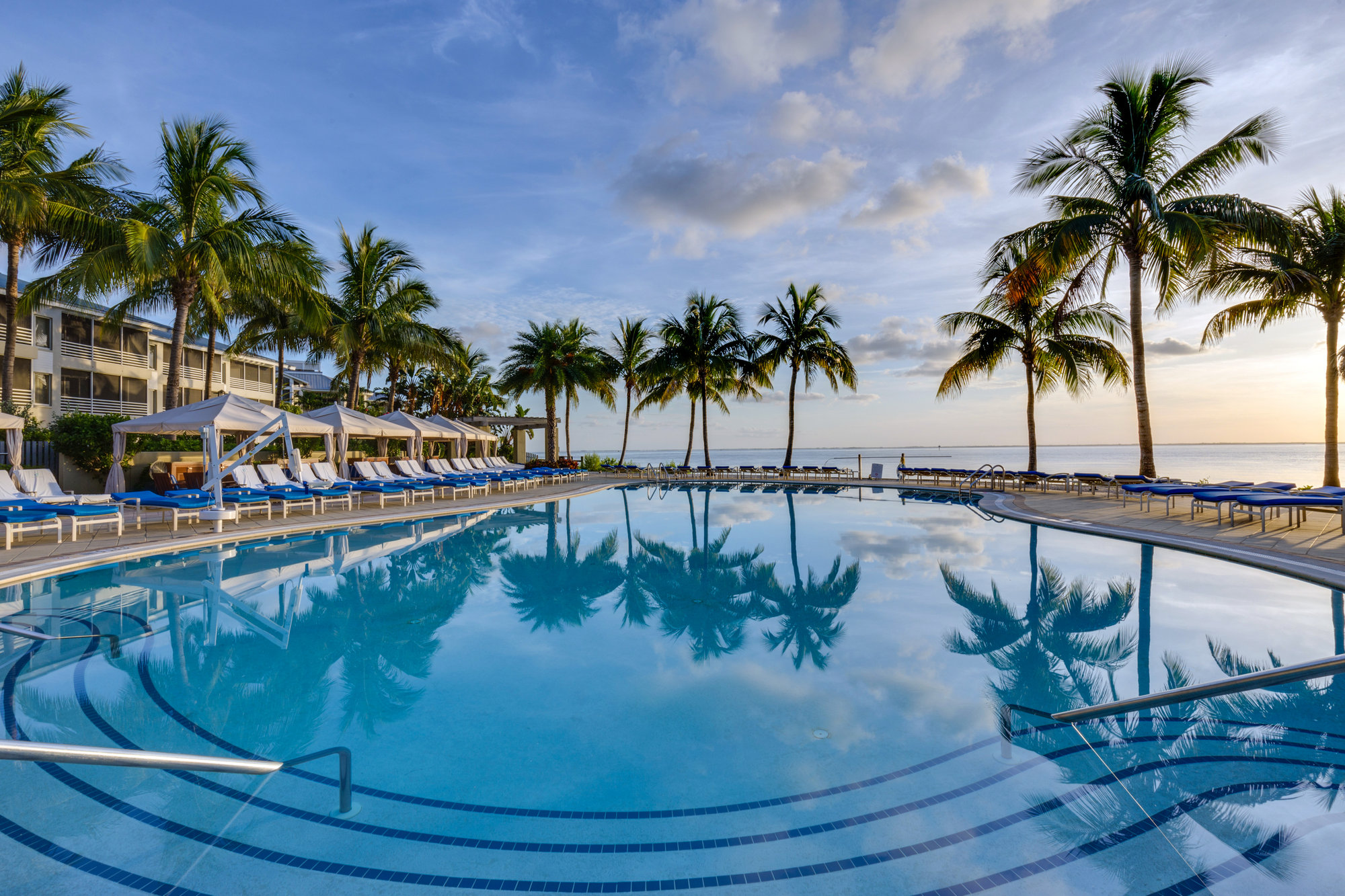 Resort pool lined with palm trees