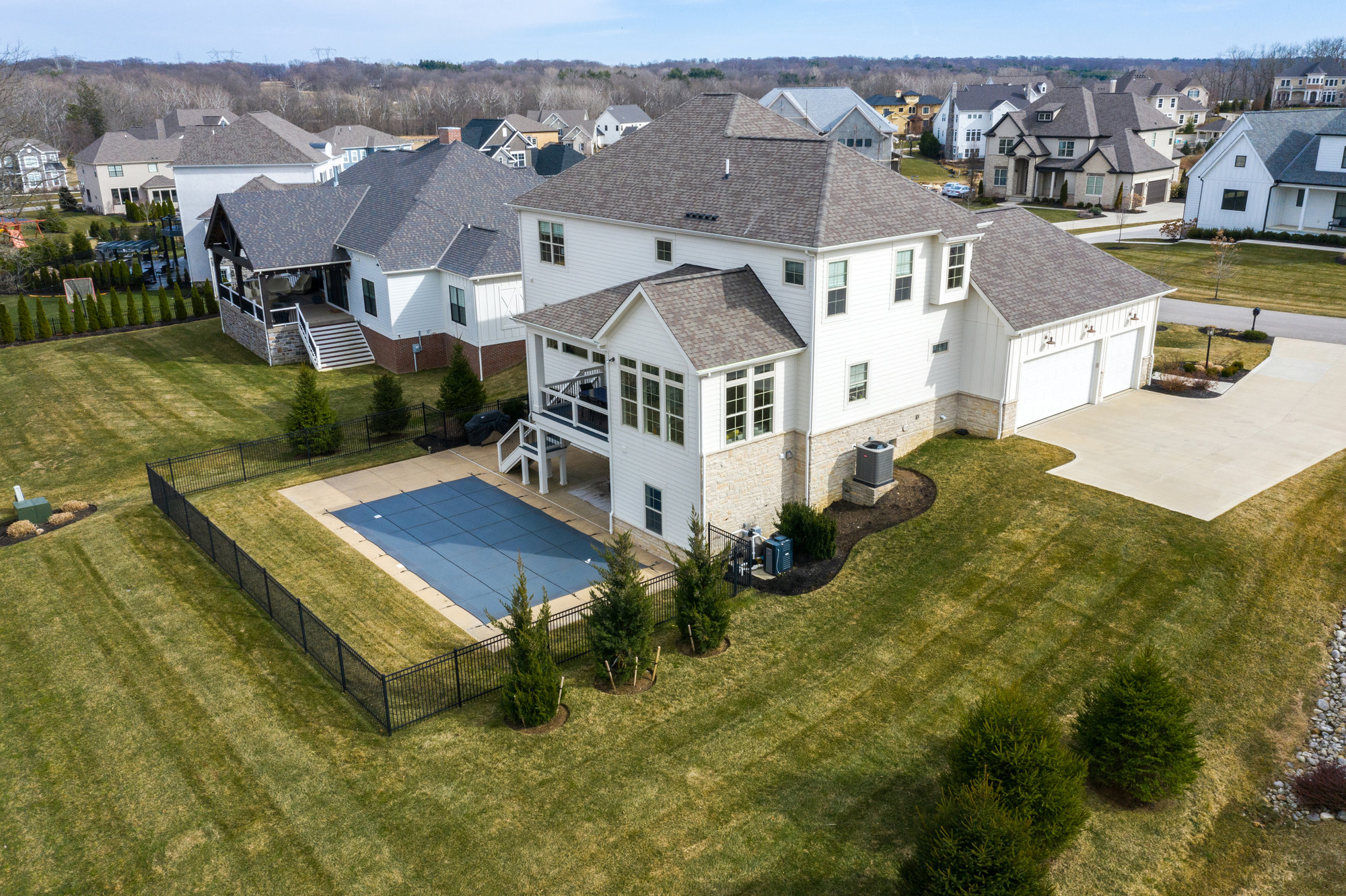 Aerial view of a home with backyard swimming pool and patio