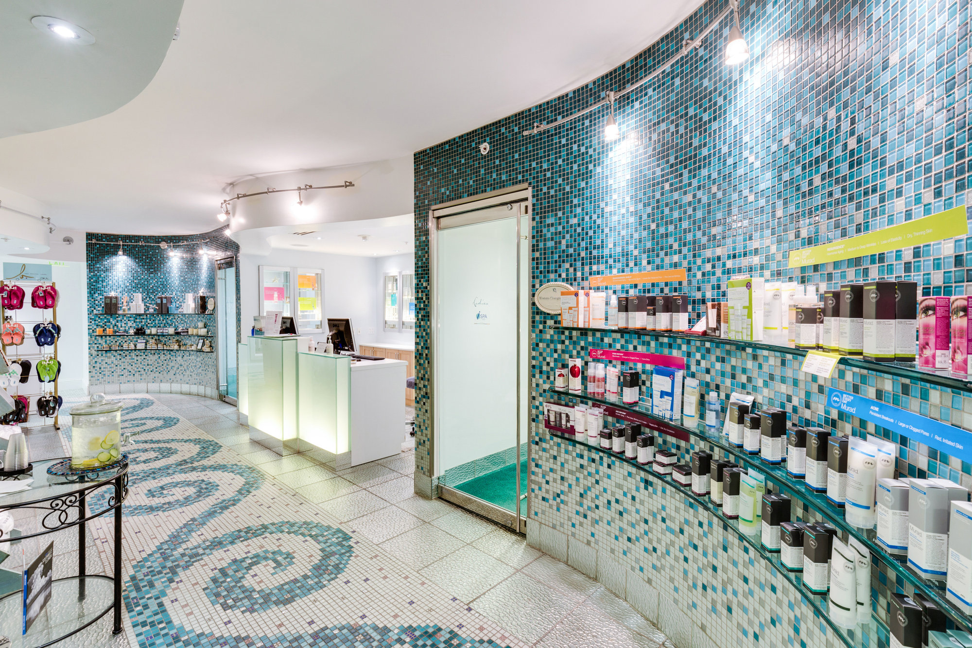 Retail boutique interior with turquoise walls and product displays