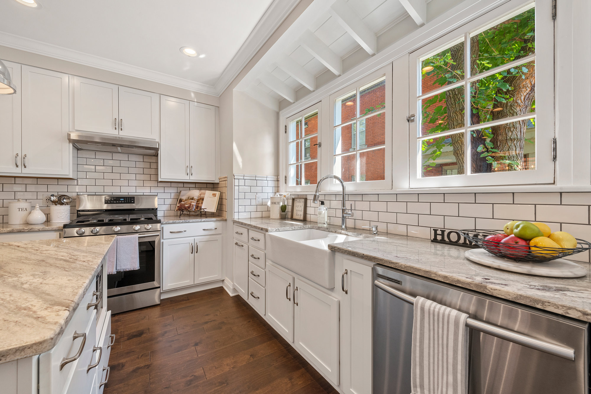 Kitchen with white countertops and wood cabinetry