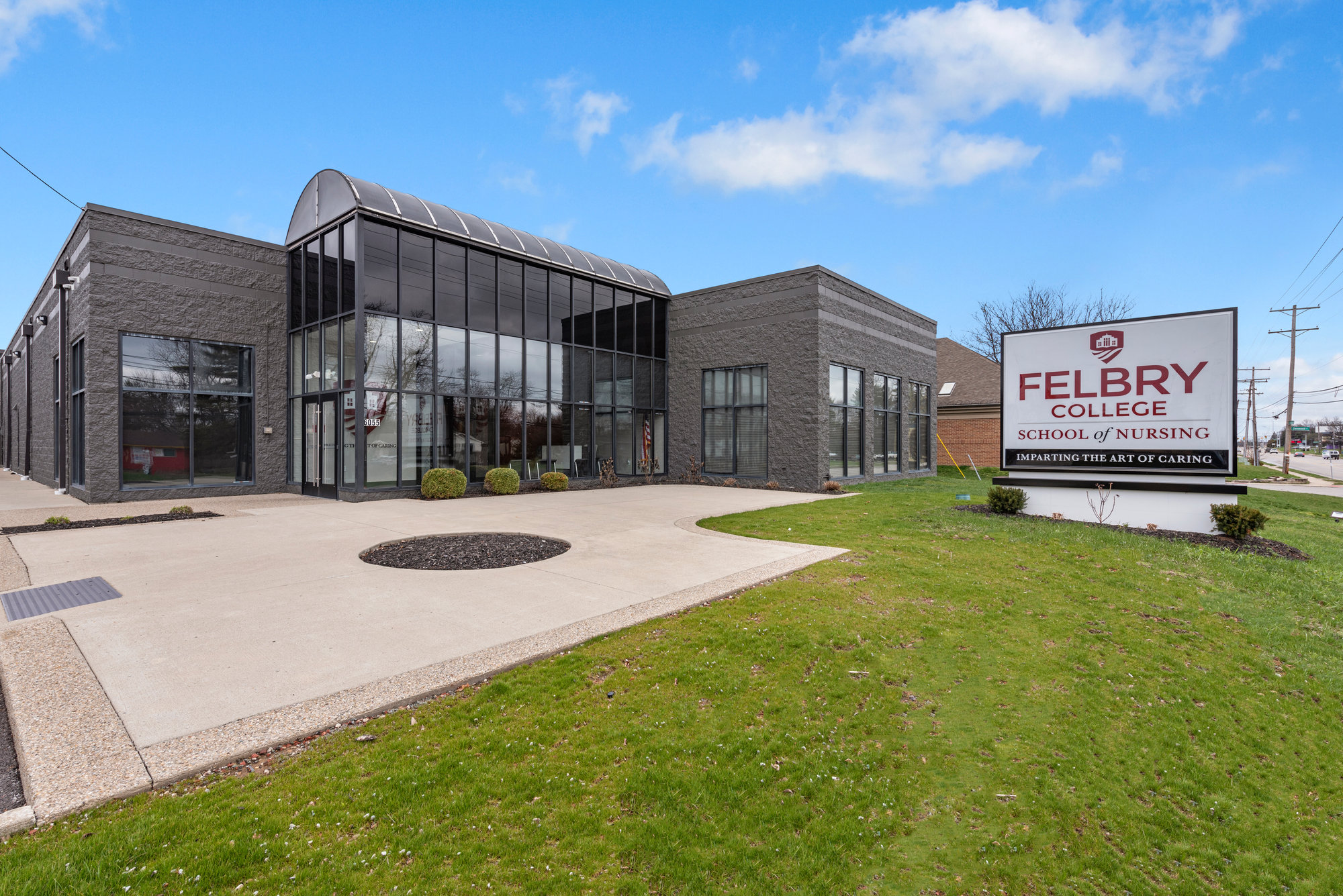 Contemporary commercial building with glass entrance and lawn