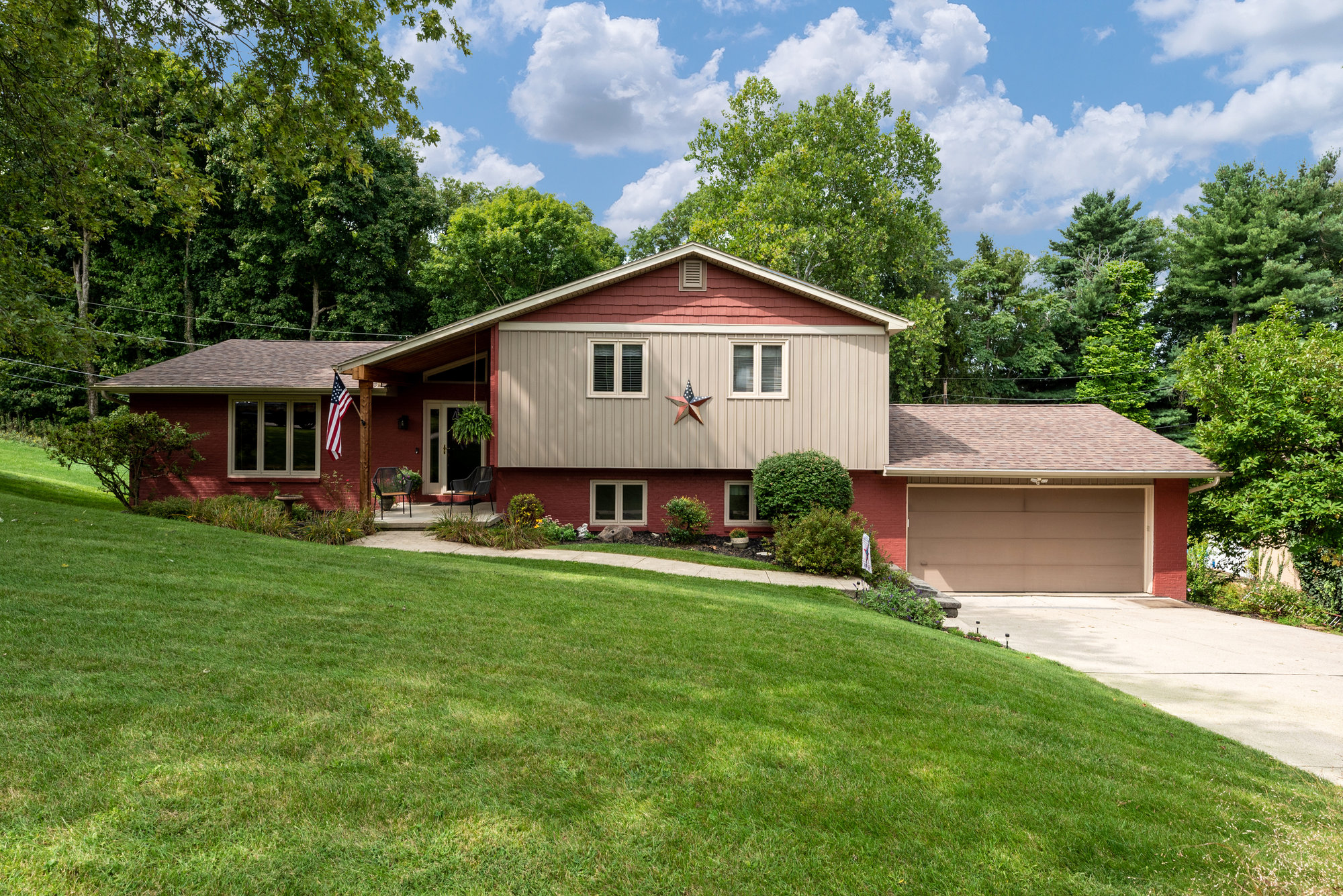 Two-story home with wood siding and a landscaped yard