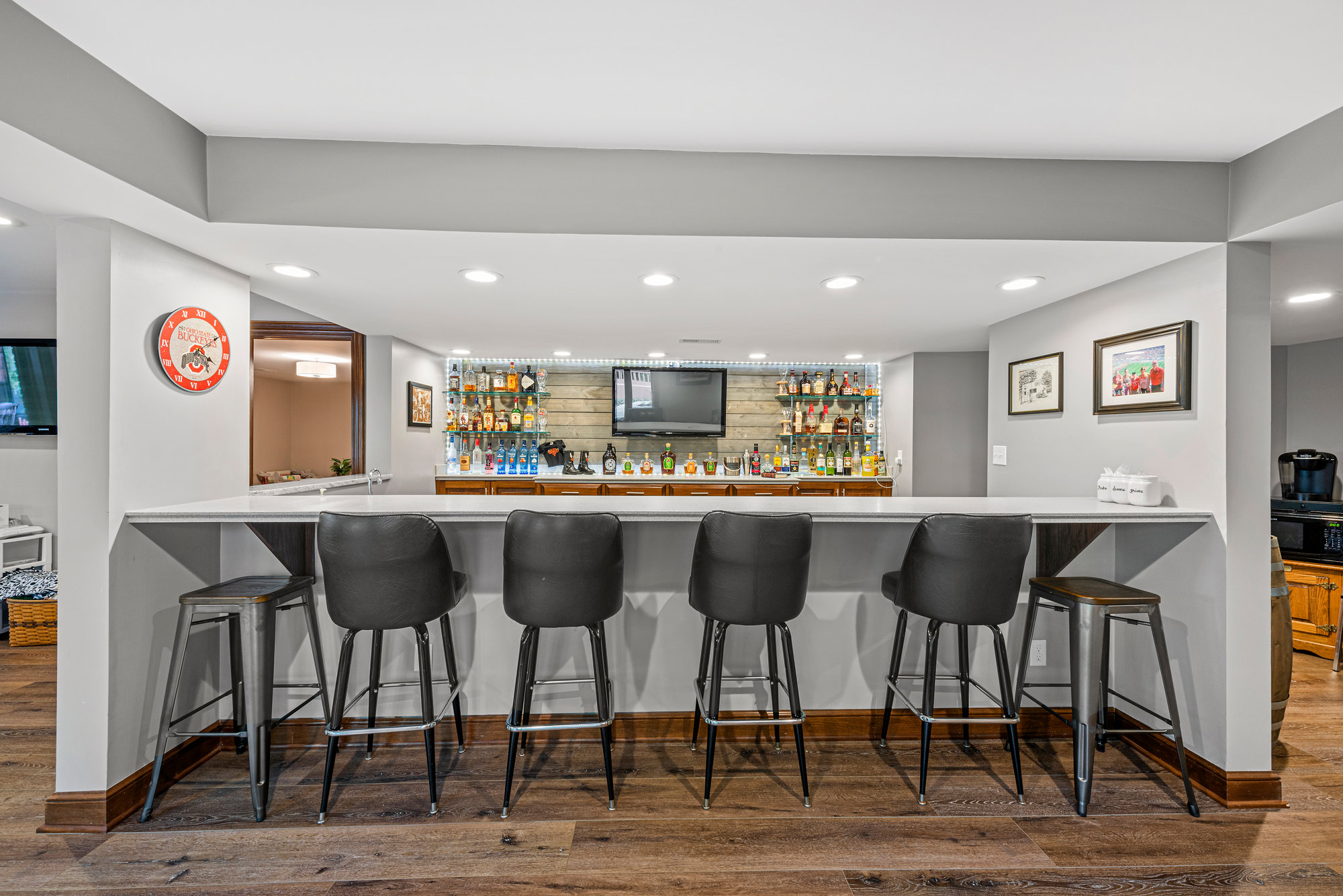 Kitchen island with bar seating and a large framed painting