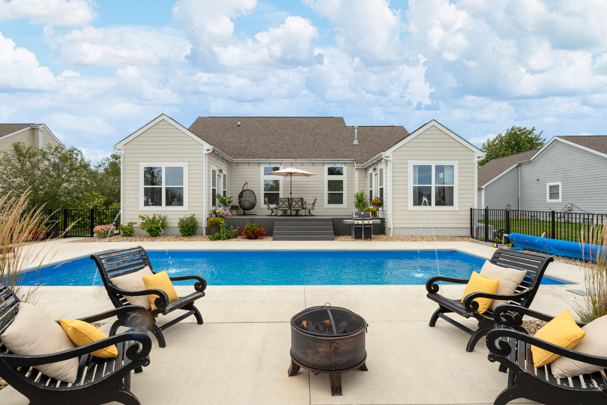 Backyard swimming pool under a blue sky